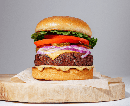 plant based burger on wooden platter