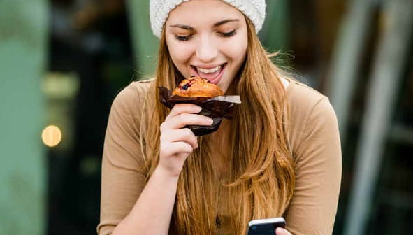 Lady eating a muffin