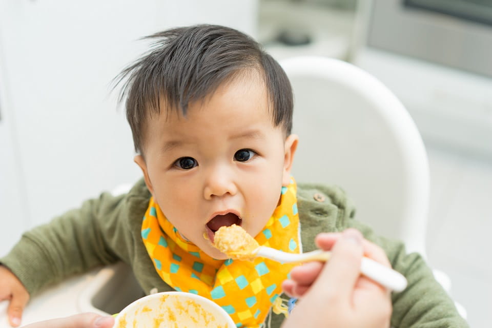 Toddler being fed