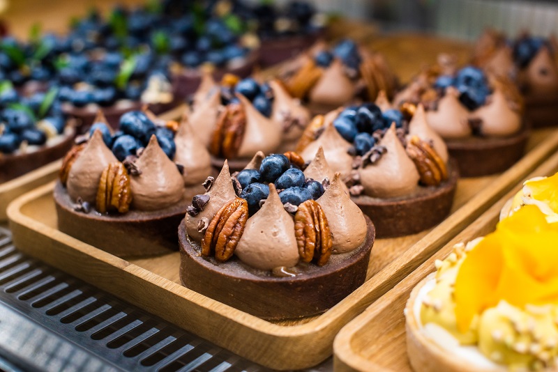 Plates with small pastries and cakes